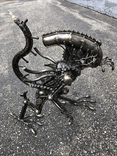 Alien made out scrap lawn - made, of